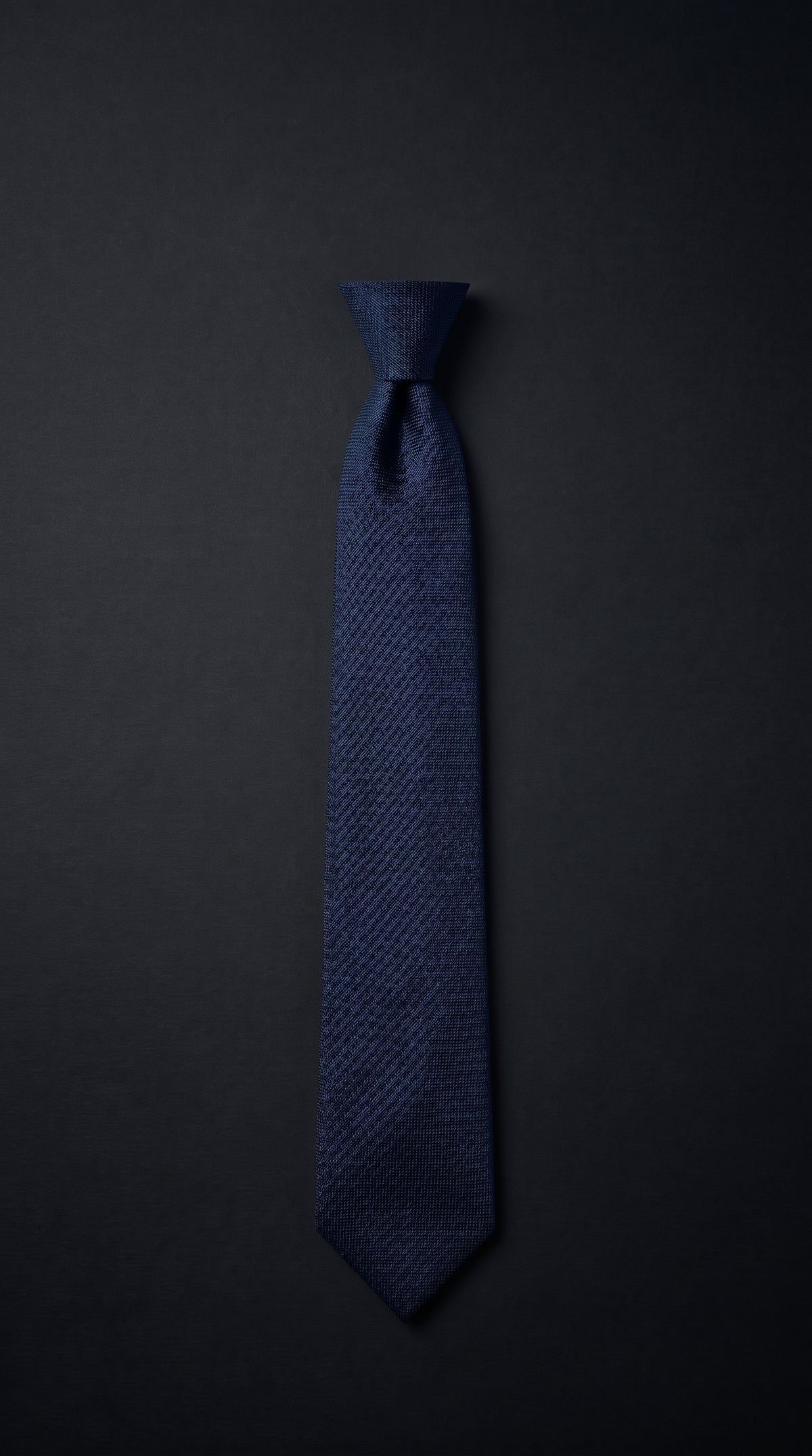 A full-length men's necktie laid flat with measurement guide